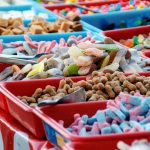 assorted-color sweet treats in red and blue plastic trays